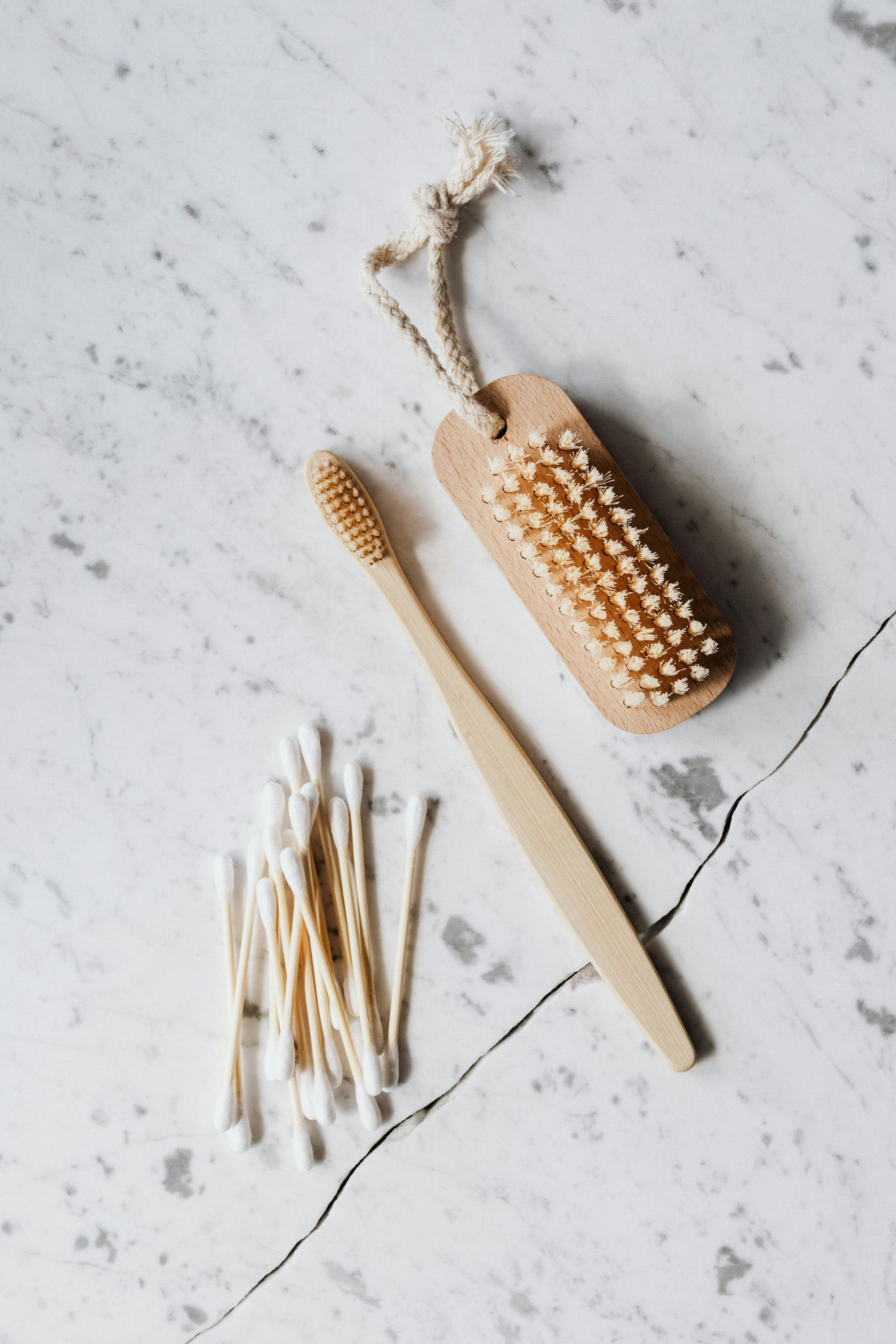 toothbrush and q-tips on marble counter