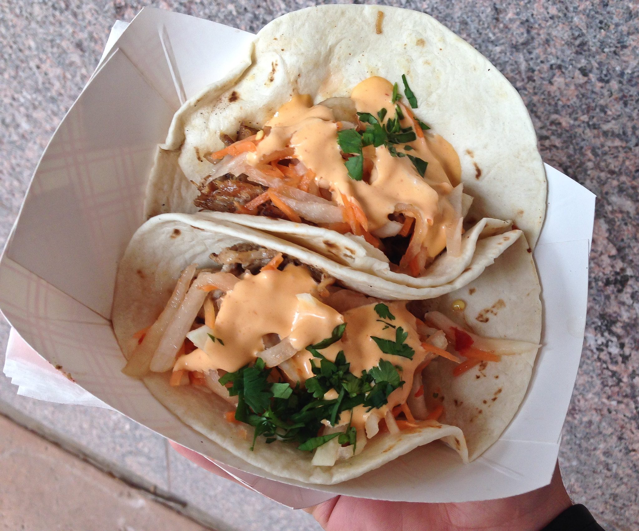 Two Bahn Mi Tacos slathered with an orange sauce