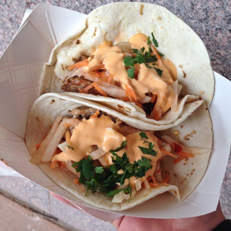 Two Bahn Mi Tacos slathered with an orange sauce