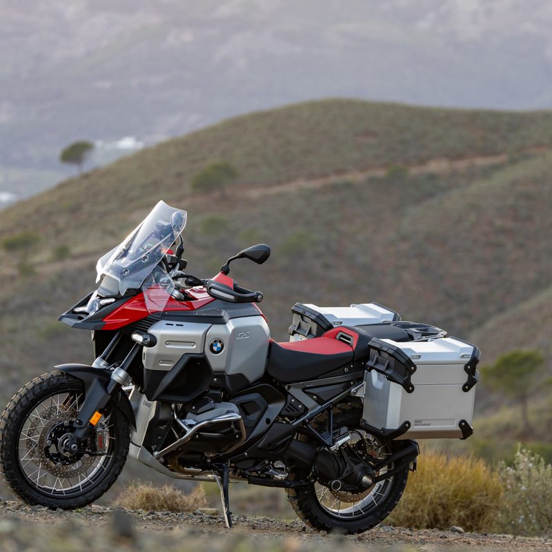2025 BMW R 1300 GS Adventure left profile view parked on a hillside with mountains in the background