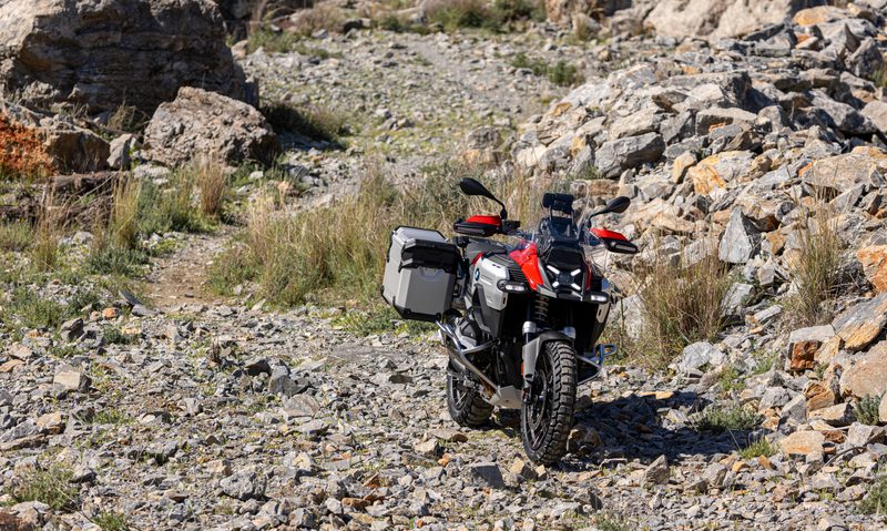 2025 BMW R 1300 GS Adventure with Adaptive Headlight Pro direct frontal view parked in rocky terrain.