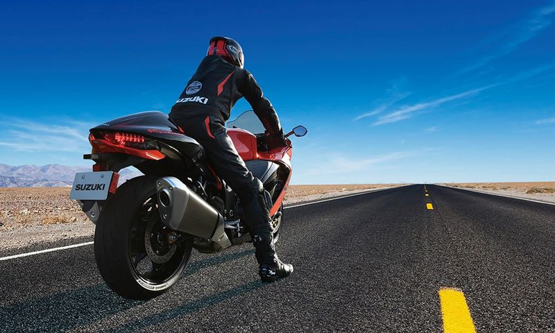 2025 Suzuki Hayabusa 25th Anniversary stopped on a road in the desert, ready for a highspeed run, right rear three-quarter view.