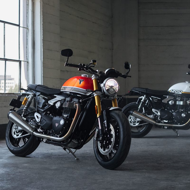 2025 Triumph Speed Twin 1200 and Speed Twin 1200 RS parked inside a brick building