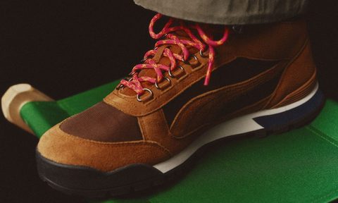 brown hiking boot on top of green chair