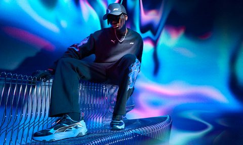 man wearing PUMA and F1 merch on bench