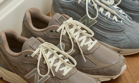 brown and blue Kith x New Balance sneakers on wood floor