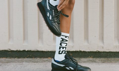model wearing black Reebok sneakers