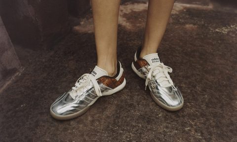 person wearing silver croc samba sneakers