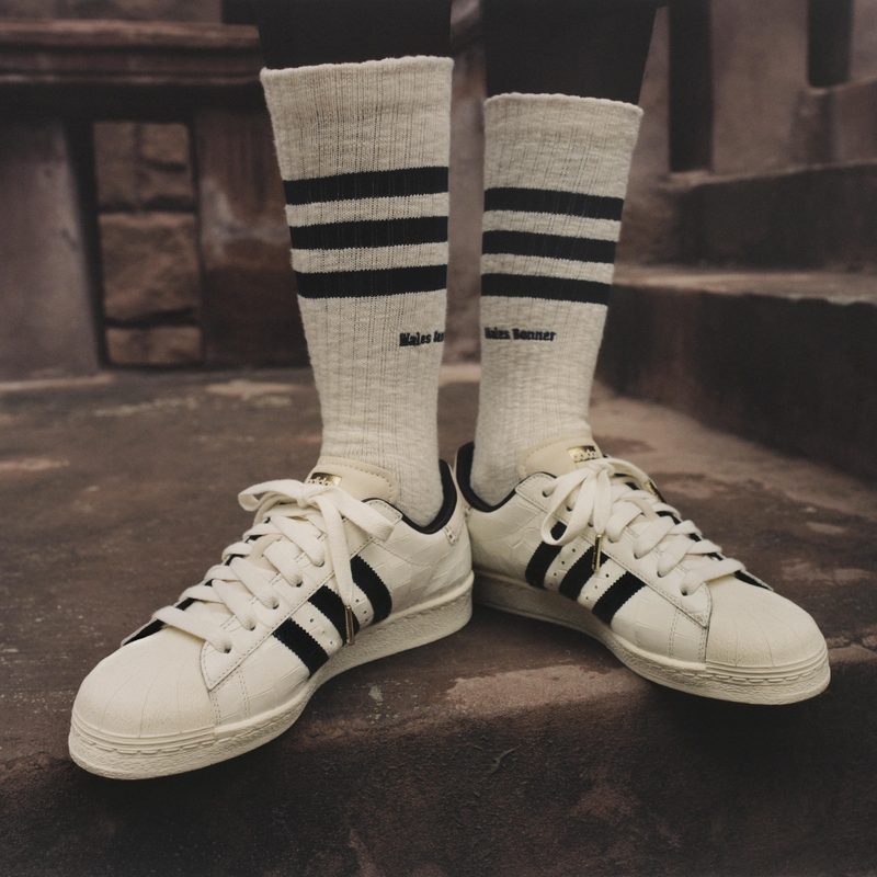 Person wearing adidas Croc Superstar sneakers