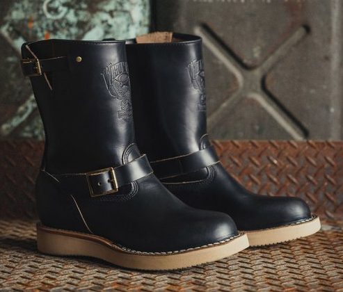 pair of black leather boots on steel box
