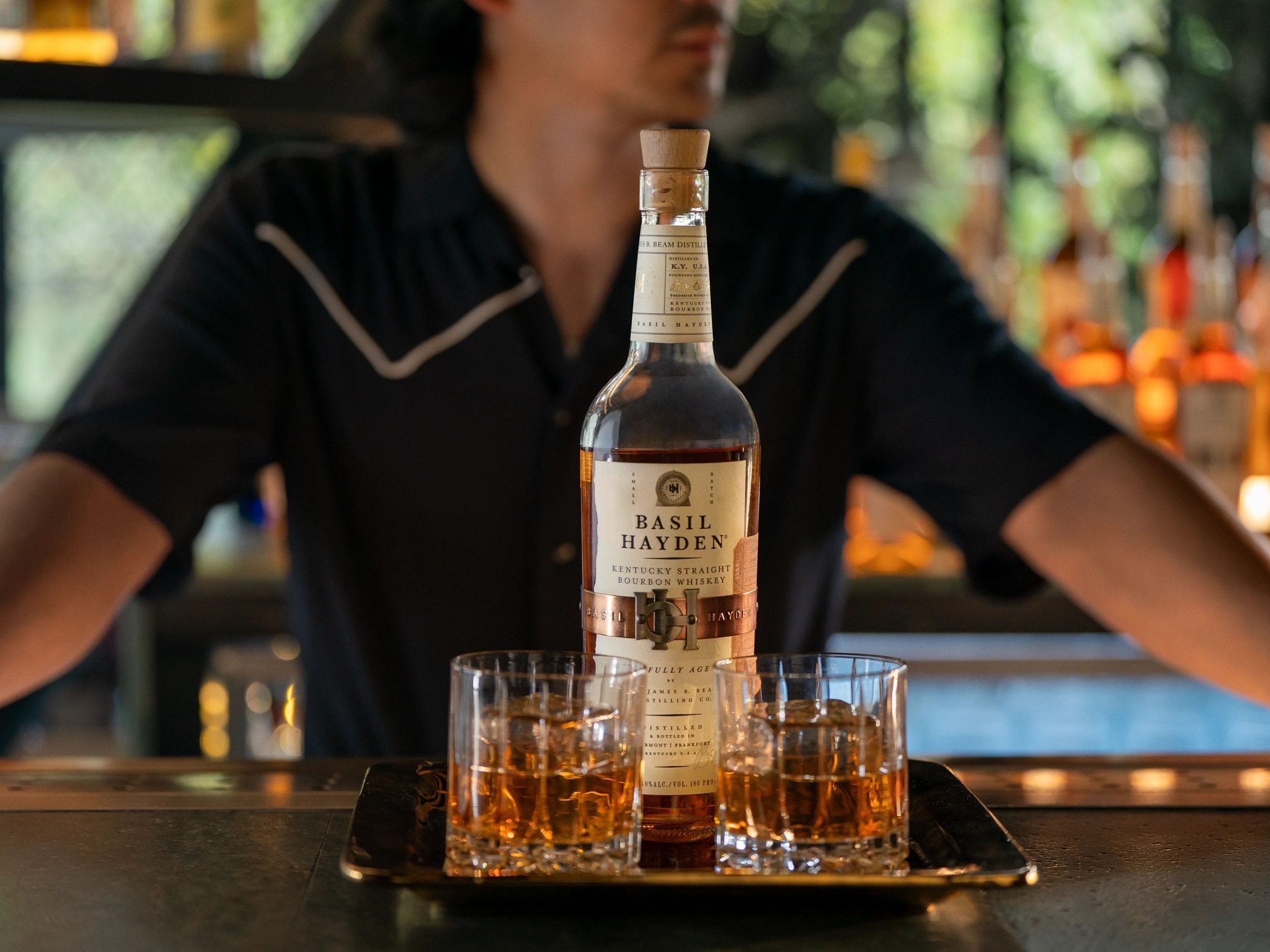 Basil Hayden Kentucky Straight Bourbon Whiskey served on a tray with glasses