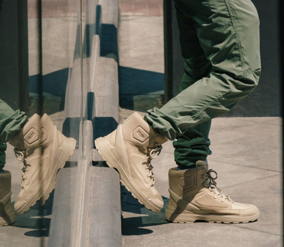 man wearing hiking boots on street
