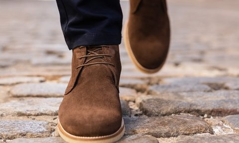 Model wearing chukka boots with suit pants