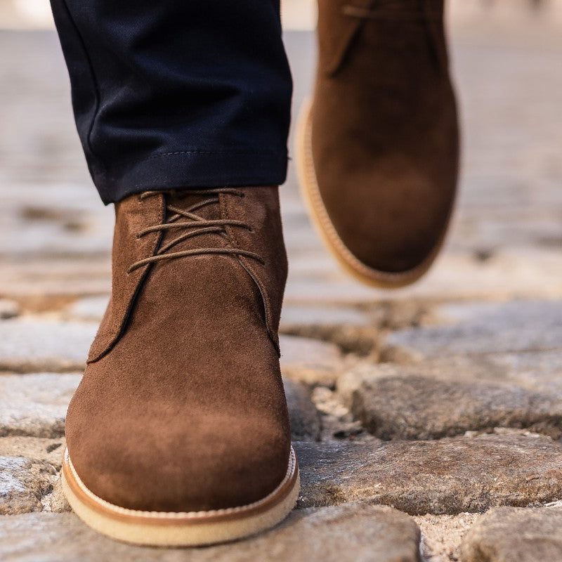 Model wearing chukka boots with suit pants