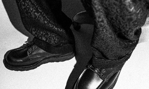 model wearing black pants and black loafers