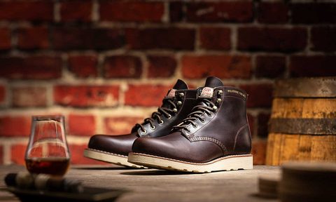 bourbon boot sitting on wood table with drink