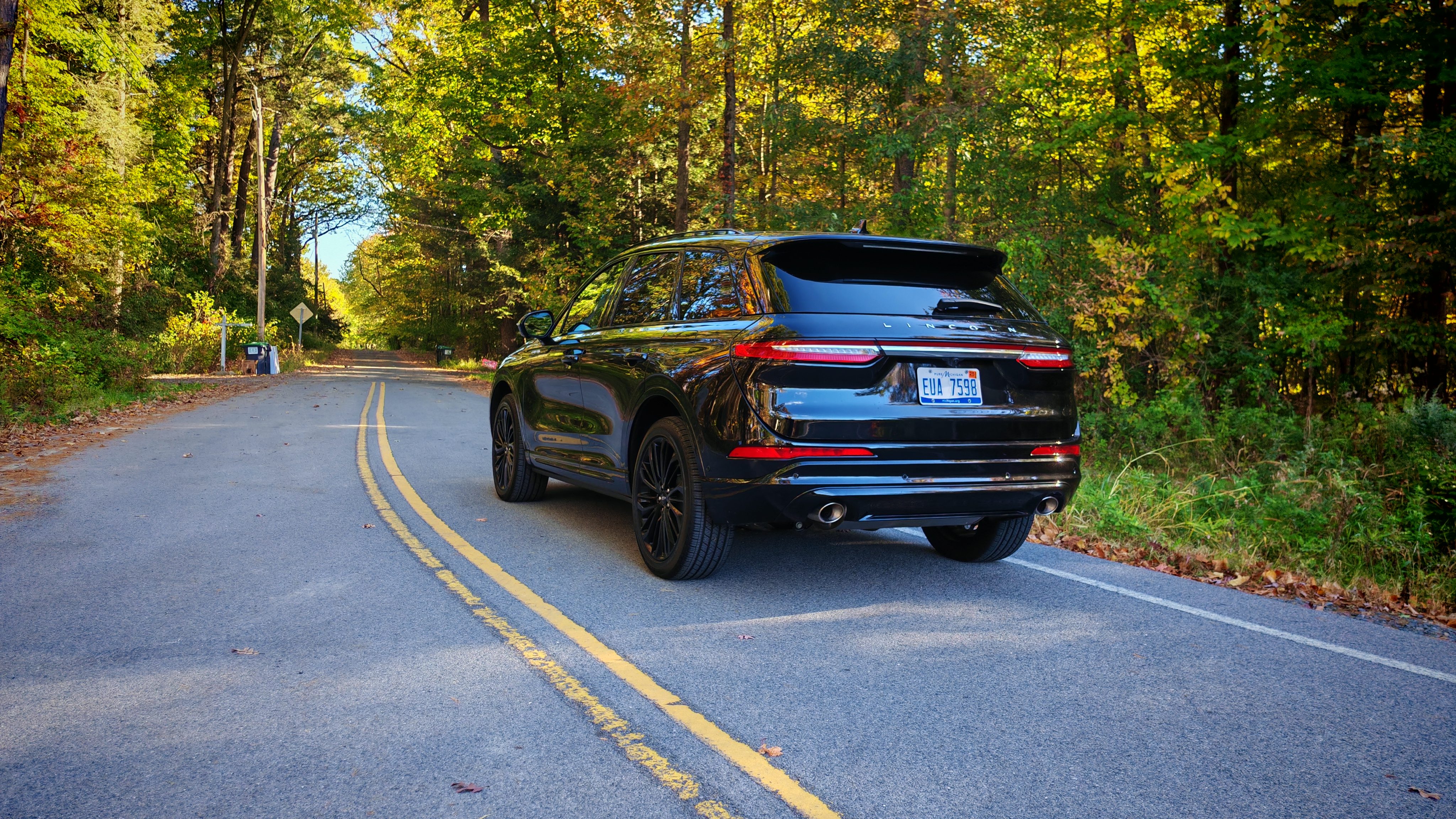 Rear view of the 2024 Lincoln Corsair on a wooded road
