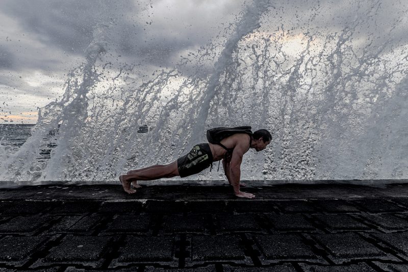 Man doing pushups on the beach