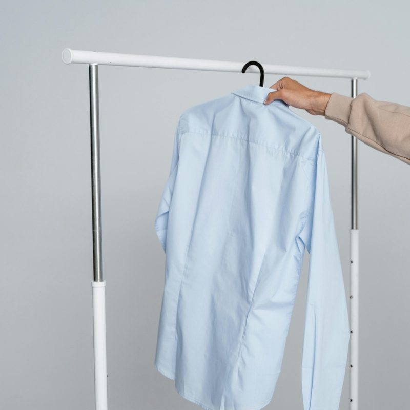 Man hanging up a shirt