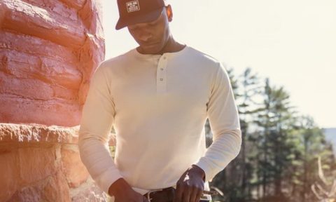 Man in a henley at a cabin