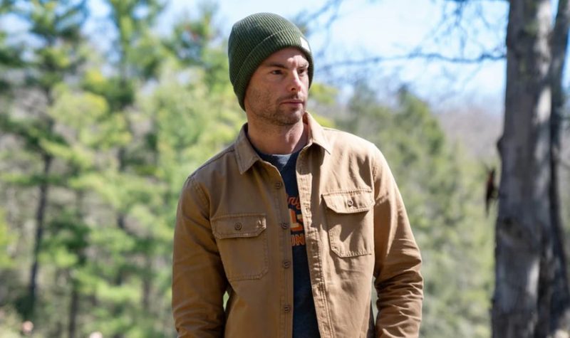 Man in beanie and shacket in the woods