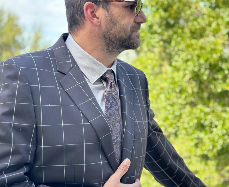 Man in brown windowpane suit