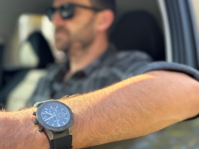 Man in car with black watch