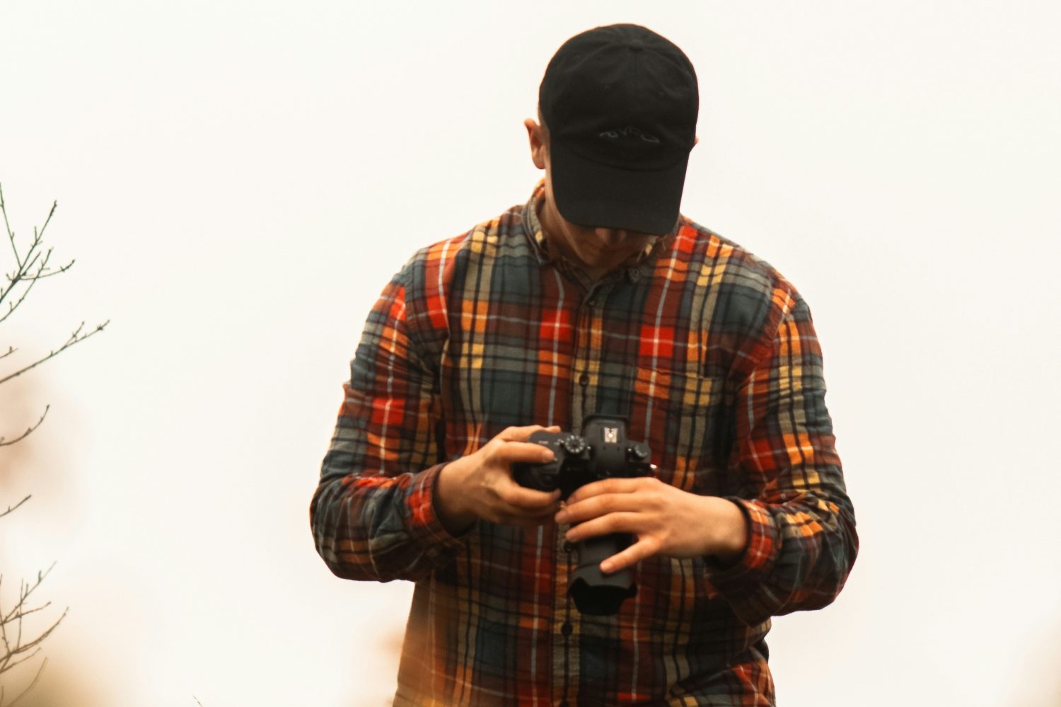 Man in flannel with camera