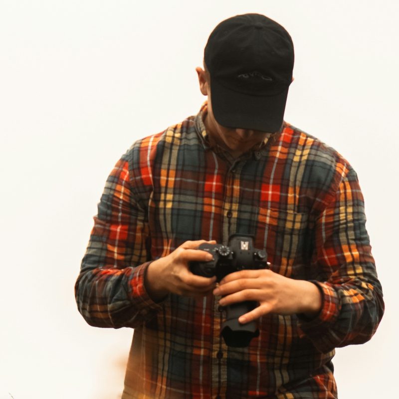 Man in flannel with camera
