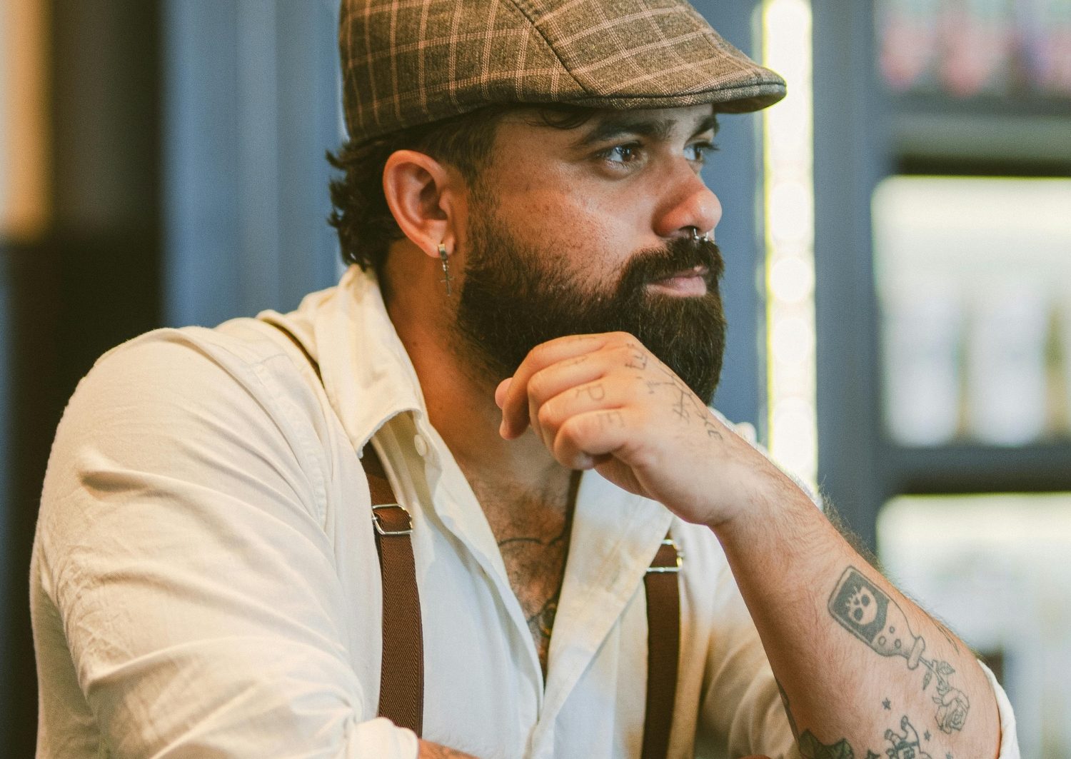 Man in flat cap and suspenders