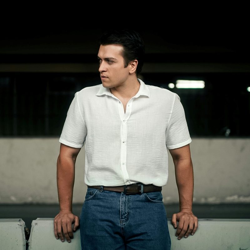 Man in jeans and white button-down shirt