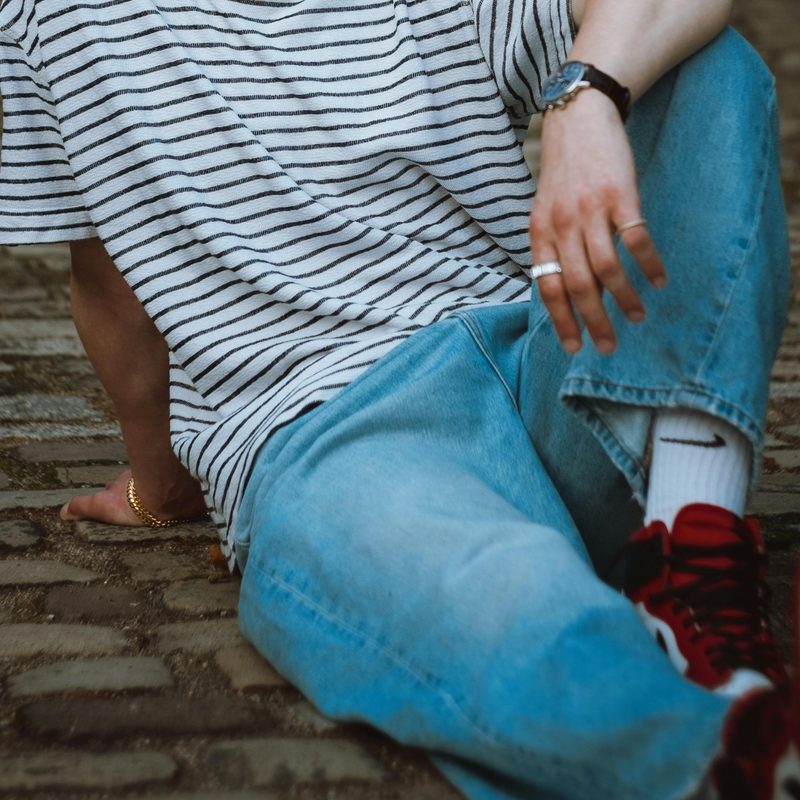 Man in jeans on the ground