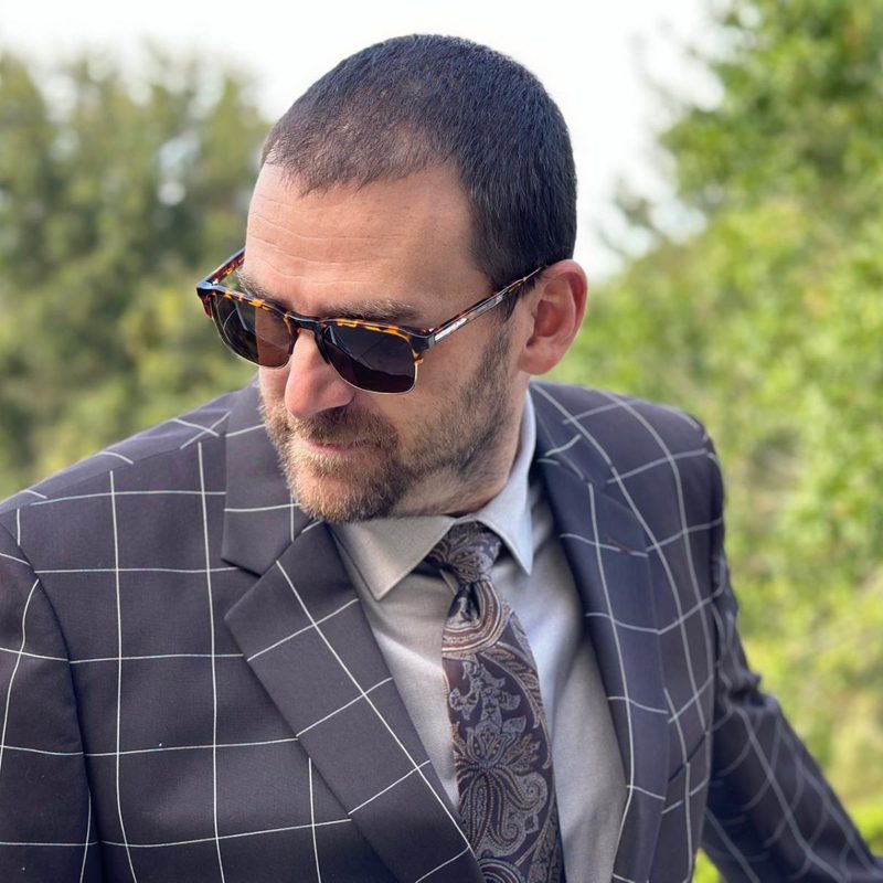Man in tan dress shirt and suit