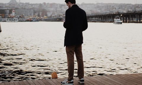 Man on a dock in a coat