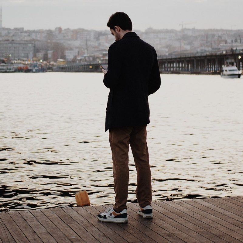 Man on a dock in a coat