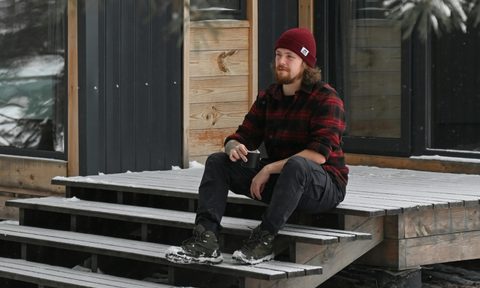 Man on steps in a flannel
