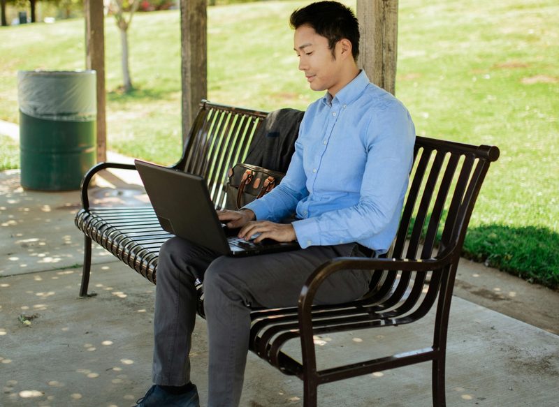 Man sitting on bench in chinos and dress shirt