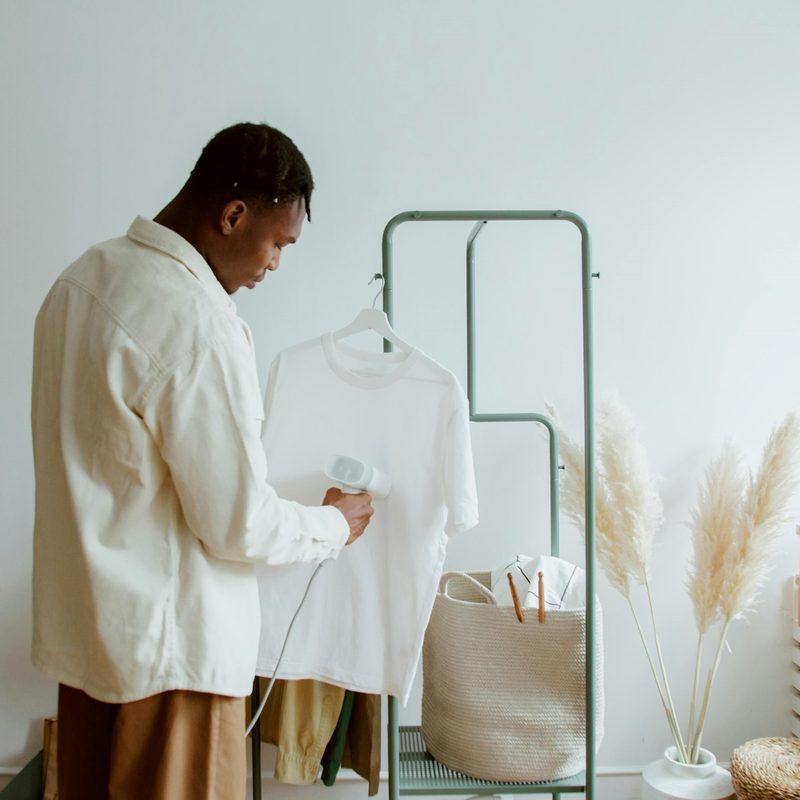 Man steaming shirt