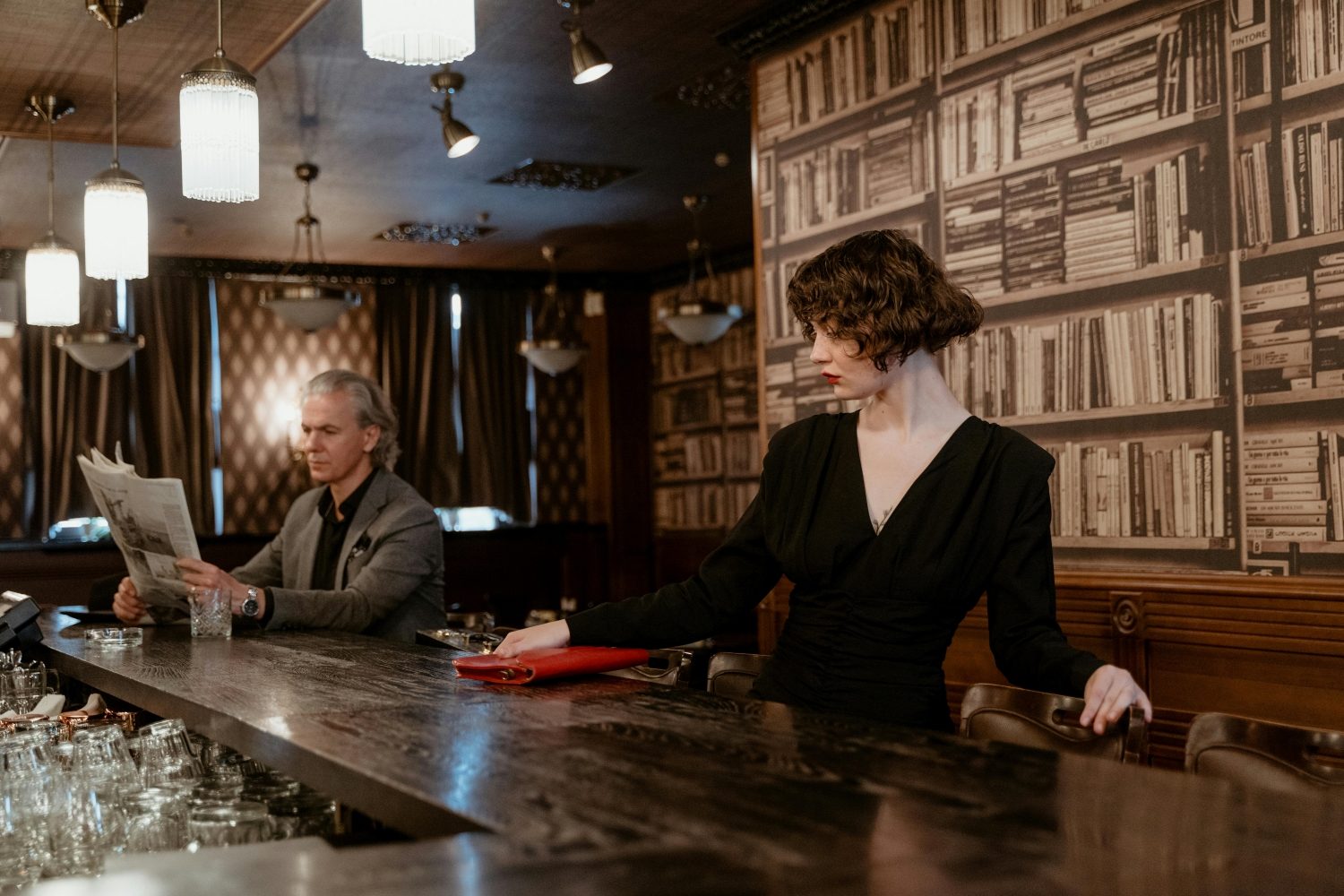 Old fashioned man at a bar with a newspaper