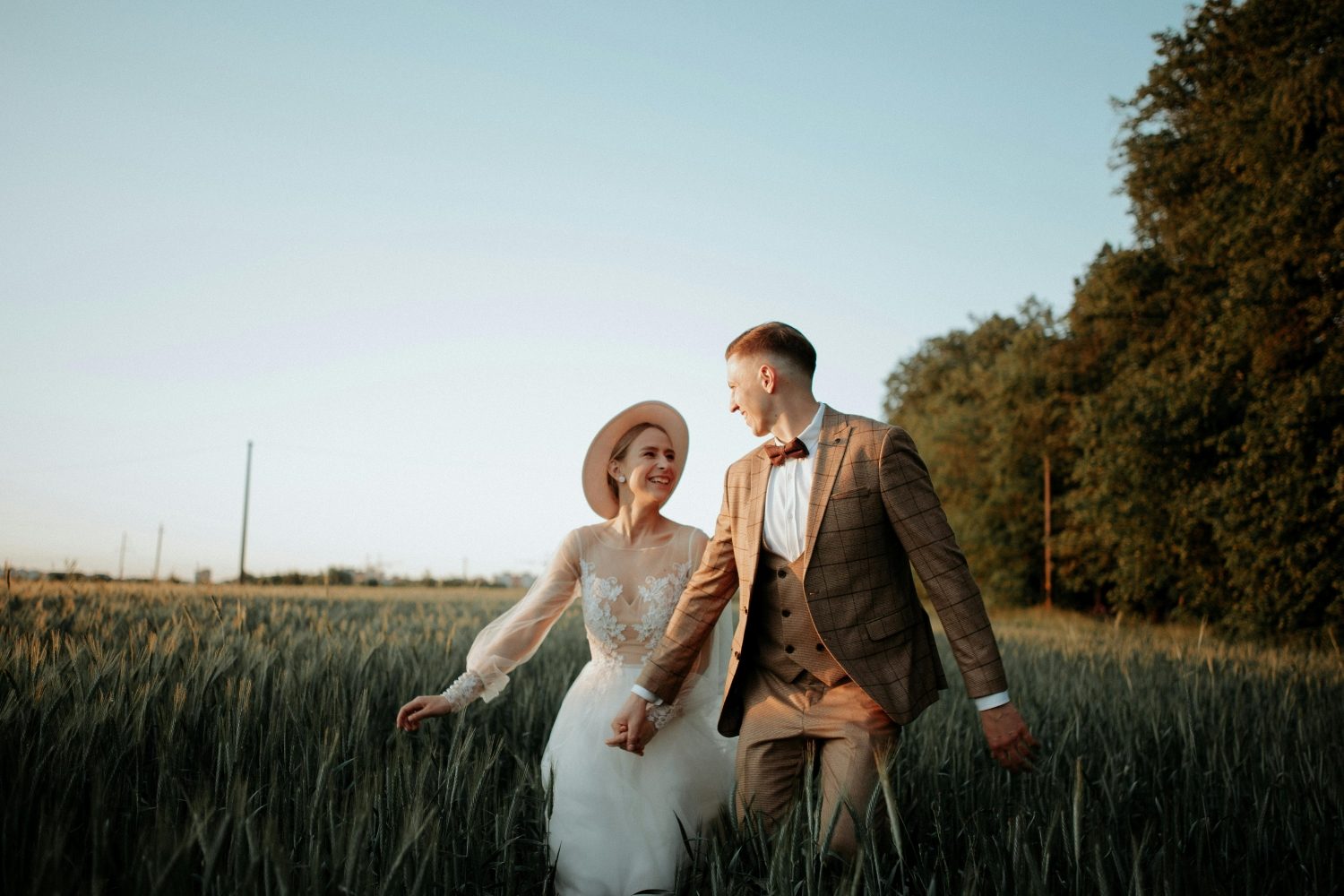 couple in a field brown suit