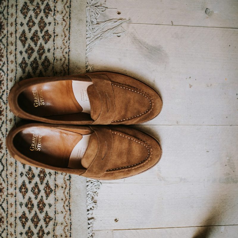 Overhead image of suede shoes on floor