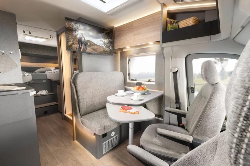 Upscale lounge/living area of Dethleff's 2025 Globebus 4x4 Performance camper bus.
