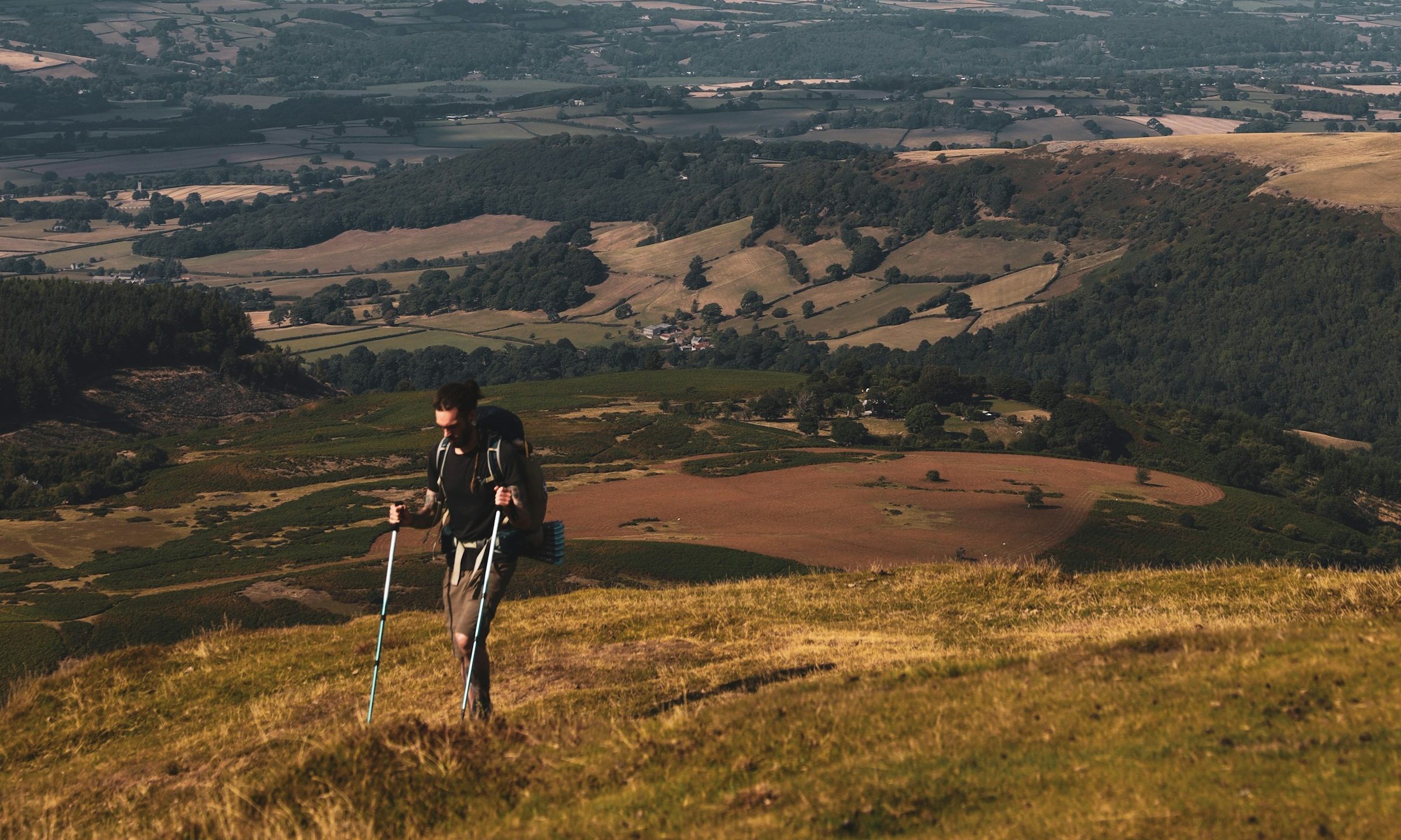 person hiking outdoors with Nordic walking poles blue sky-