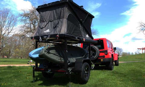 Red Jeep towing a Hiker Trailers GearLoft travel trailer/micro-camper.