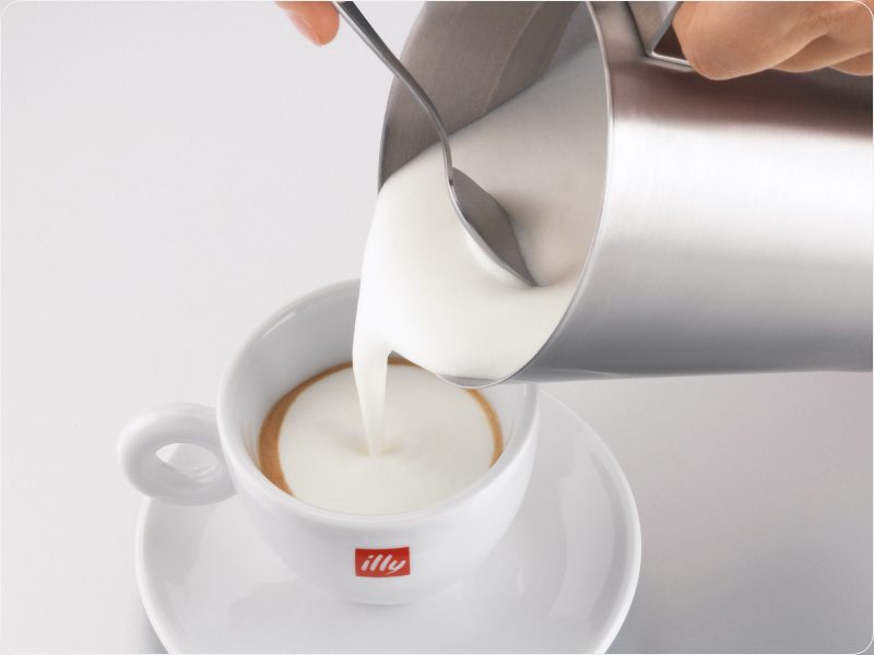 pouring milk into coffee