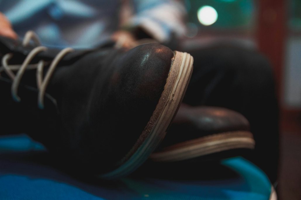 black lace up boots on bed