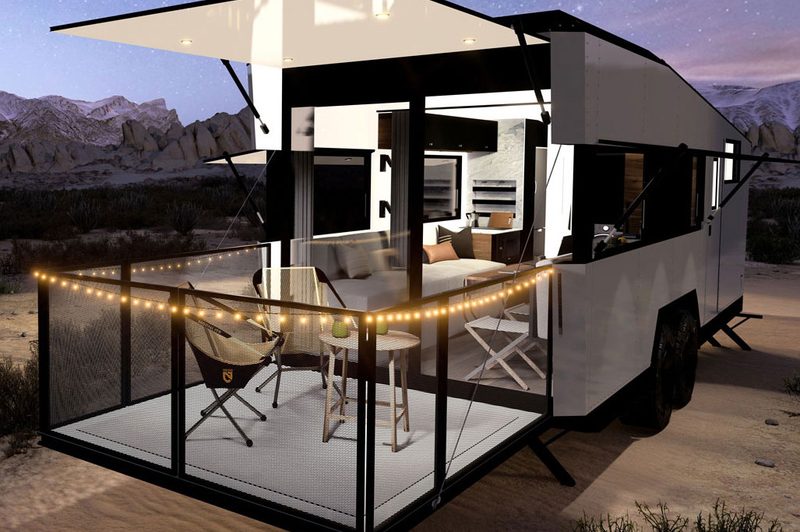 Rendering of the rear deck/patio of the 2025 CyberTrailer travel trailer lit up at night.