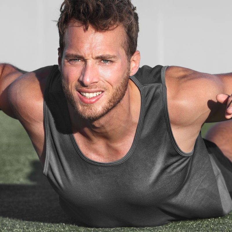 Man doing Superman exercise outside