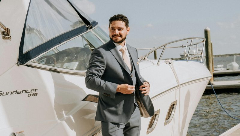 Man in a suit by a boat