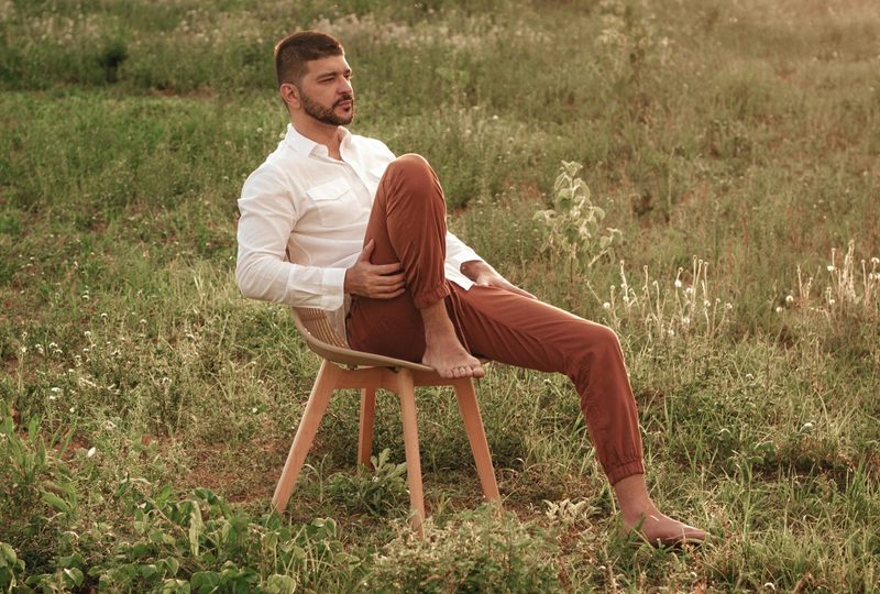 man in chinos in field